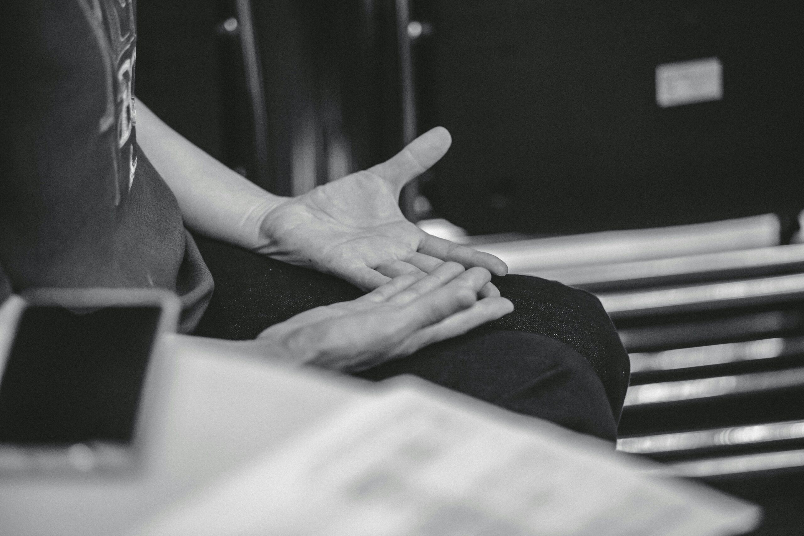 Hands held open in lap